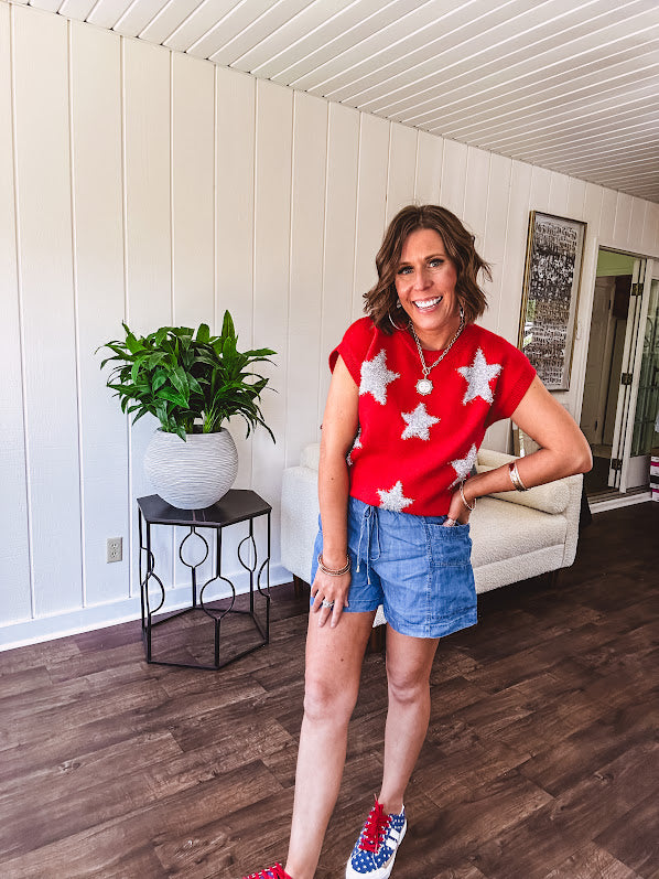 Bold red sweater vest with silver fuzzy stars throughout.