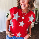 Bold red sweater vest with silver fuzzy stars throughout.