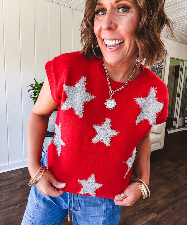 Bold red sweater vest with silver fuzzy stars throughout.