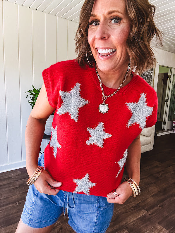 Bold red sweater vest with silver fuzzy stars throughout.