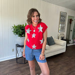 Bold red sweater vest with silver fuzzy stars throughout.