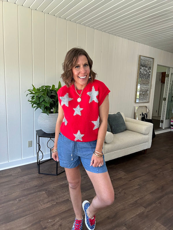 Bold red sweater vest with silver fuzzy stars throughout.