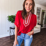 Cool red dolman style top with white and red gingham trim at the mock neck and yoke.