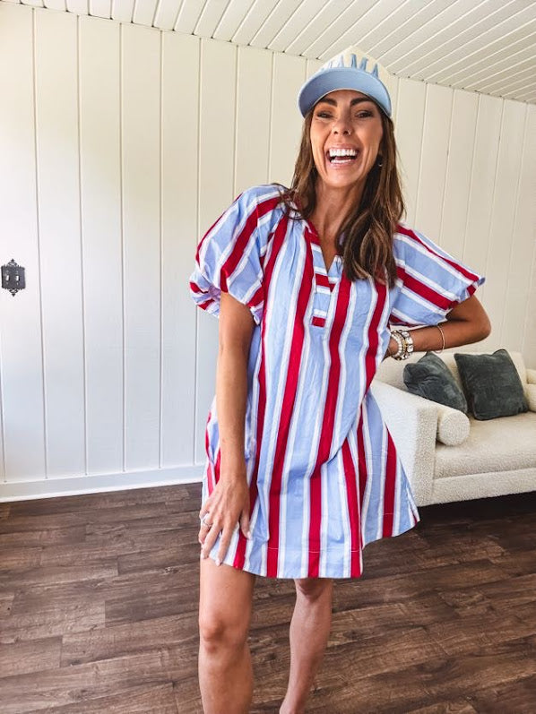 Light blue, white and red striped mini dress featuring a V neck and mock collar, puffed sleeves and pockets.