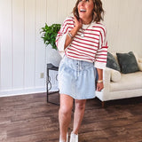 Soft cream and red striped 3/4 sleeve sweater with ribbed round neck, loose cuffs and hem.