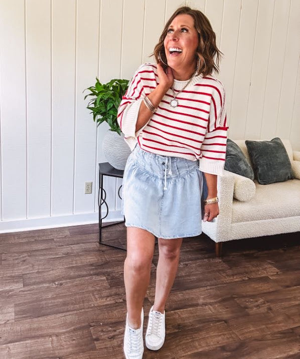 Soft cream and red striped 3/4 sleeve sweater with ribbed round neck, loose cuffs and hem.