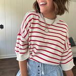 Soft cream and red striped 3/4 sleeve sweater with ribbed round neck, loose cuffs and hem.