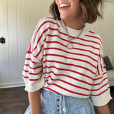 Soft cream and red striped 3/4 sleeve sweater with ribbed round neck, loose cuffs and hem.