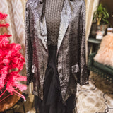 Black long sleeved mesh with gold diamond pattern.