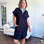 The scoop hem is a flattering fit that is sure to be the star of the show. This black 1/4 zip dress combines comfort with contemporary style, featuring a distinctive scoop hem that creates an elegant silhouette.