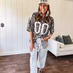 Camo print jersey featuring black and white trim at the V neck, white satin trim down the shoulders and a double 0 on the front.