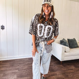 Camo print jersey featuring black and white trim at the V neck, white satin trim down the shoulders and a double 0 on the front.