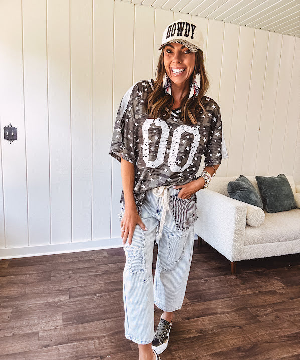 Camo print jersey featuring black and white trim at the V neck, white satin trim down the shoulders and a double 0 on the front.