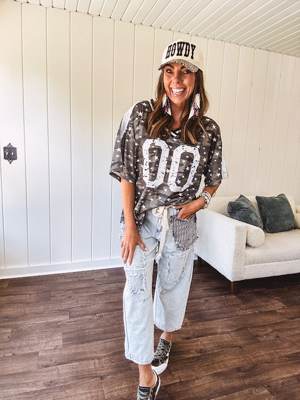 Camo print jersey featuring black and white trim at the V neck, white satin trim down the shoulders and a double 0 on the front.