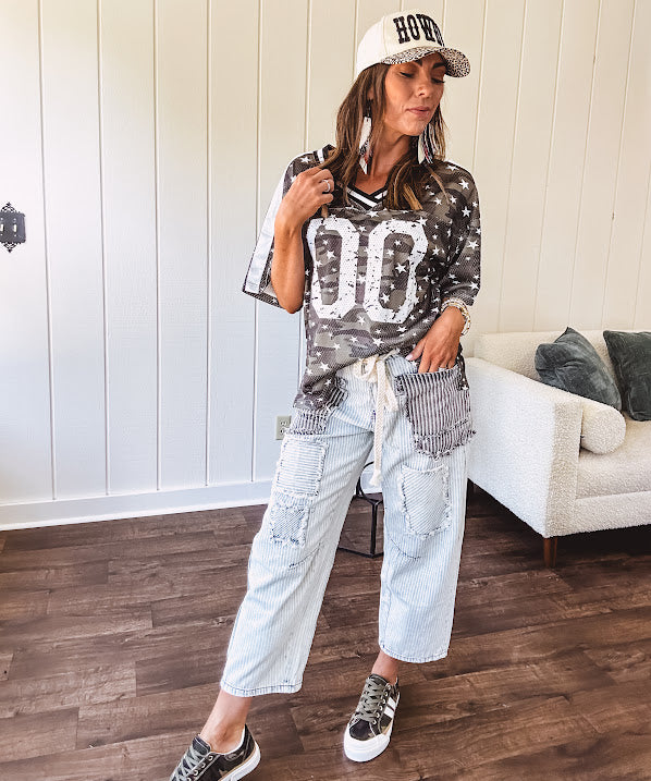 Camo print jersey featuring black and white trim at the V neck, white satin trim down the shoulders and a double 0 on the front.