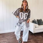 Camo print jersey featuring black and white trim at the V neck, white satin trim down the shoulders and a double 0 on the front.