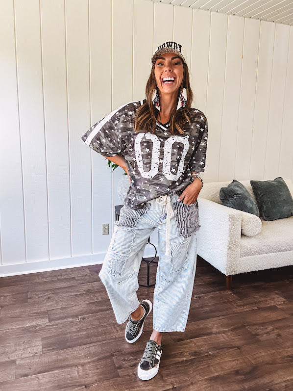Camo print jersey featuring black and white trim at the V neck, white satin trim down the shoulders and a double 0 on the front.