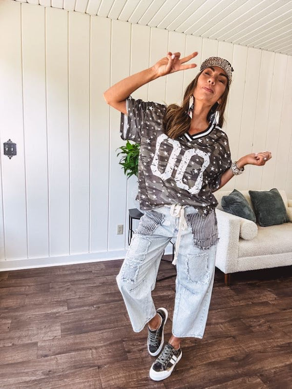 Camo print jersey featuring black and white trim at the V neck, white satin trim down the shoulders and a double 0 on the front.