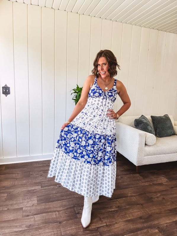 Blue and white floral maxi dress with tiered skirt, tie at the bodice, adjustable skinny straps and fully lined with smocking at the back.