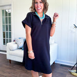 The scoop hem is a flattering fit that is sure to be the star of the show. This black 1/4 zip dress combines comfort with contemporary style, featuring a distinctive scoop hem that creates an elegant silhouette.