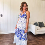 Blue and white floral maxi dress with tiered skirt, tie at the bodice, adjustable skinny straps and fully lined with smocking at the back.