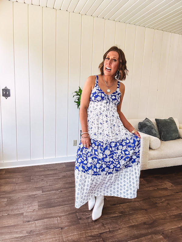 Blue and white floral maxi dress with tiered skirt, tie at the bodice, adjustable skinny straps and fully lined with smocking at the back.