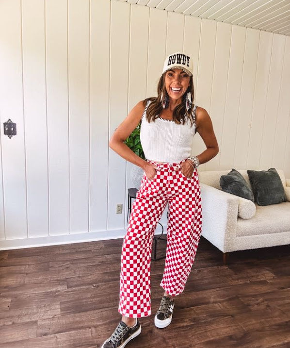 Thin, stretchy red and white checkered barrel pants with button and zipper closure.
