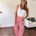 Thin, stretchy red and white checkered barrel pants with button and zipper closure.