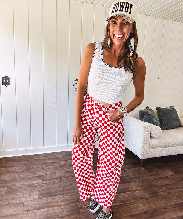 Thin, stretchy red and white checkered barrel pants with button and zipper closure.