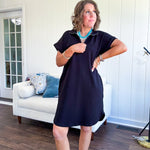 The scoop hem is a flattering fit that is sure to be the star of the show. This black 1/4 zip dress combines comfort with contemporary style, featuring a distinctive scoop hem that creates an elegant silhouette.