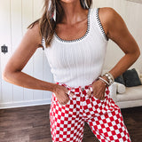 Thin, stretchy red and white checkered barrel pants with button and zipper closure.