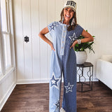 Soft terry-like cotton jumpsuit in indigo and light blue stripes with star patches throughout with lace embellishments. Wide lg design and faux wooden buttons down the front.