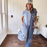 Soft terry-like cotton jumpsuit in indigo and light blue stripes with star patches throughout with lace embellishments. Wide lg design and faux wooden buttons down the front.