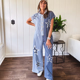 Soft terry-like cotton jumpsuit in indigo and light blue stripes with star patches throughout with lace embellishments. Wide lg design and faux wooden buttons down the front.