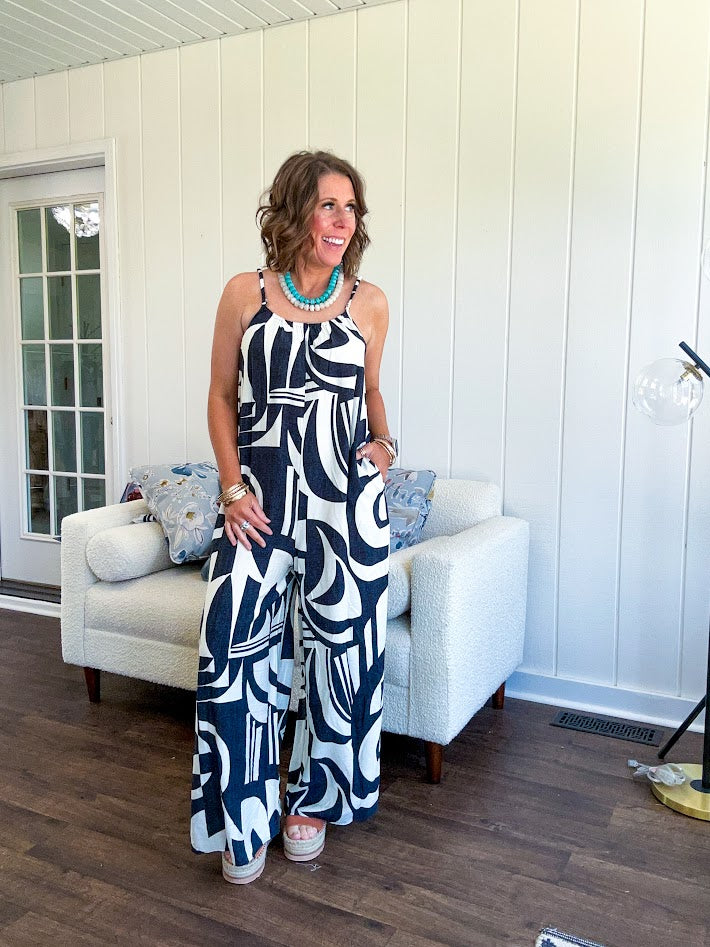 Turn heads this season in our Black + Cream Abstract Trellis Jumpsuit—the effortless piece that does all the work for you. Crafted from lightweight, breathable polyester, this playful abstract print jumpsuit features adjustable straps with a drawstring at the back, elastic neckline details, and a flattering wide-leg silhouette that moves with you. 