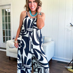 Turn heads this season in our Black + Cream Abstract Trellis Jumpsuit—the effortless piece that does all the work for you. Crafted from lightweight, breathable polyester, this playful abstract print jumpsuit features adjustable straps with a drawstring at the back, elastic neckline details, and a flattering wide-leg silhouette that moves with you. 