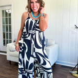 Turn heads this season in our Black + Cream Abstract Trellis Jumpsuit—the effortless piece that does all the work for you. Crafted from lightweight, breathable polyester, this playful abstract print jumpsuit features adjustable straps with a drawstring at the back, elastic neckline details, and a flattering wide-leg silhouette that moves with you. 