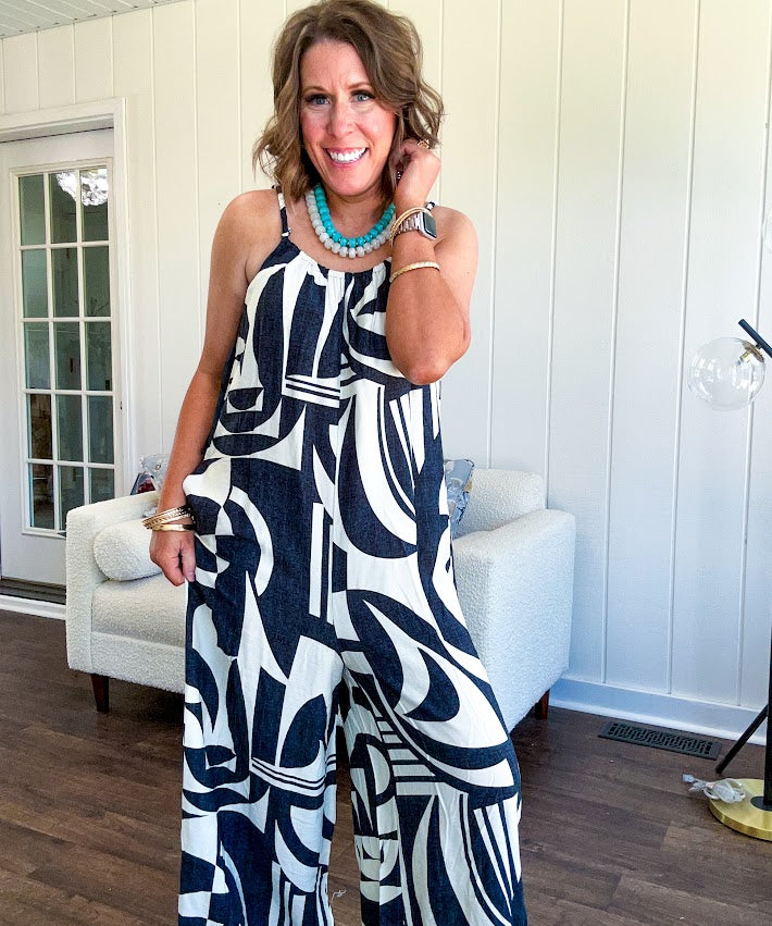 Turn heads this season in our Black + Cream Abstract Trellis Jumpsuit—the effortless piece that does all the work for you. Crafted from lightweight, breathable polyester, this playful abstract print jumpsuit features adjustable straps with a drawstring at the back, elastic neckline details, and a flattering wide-leg silhouette that moves with you. 