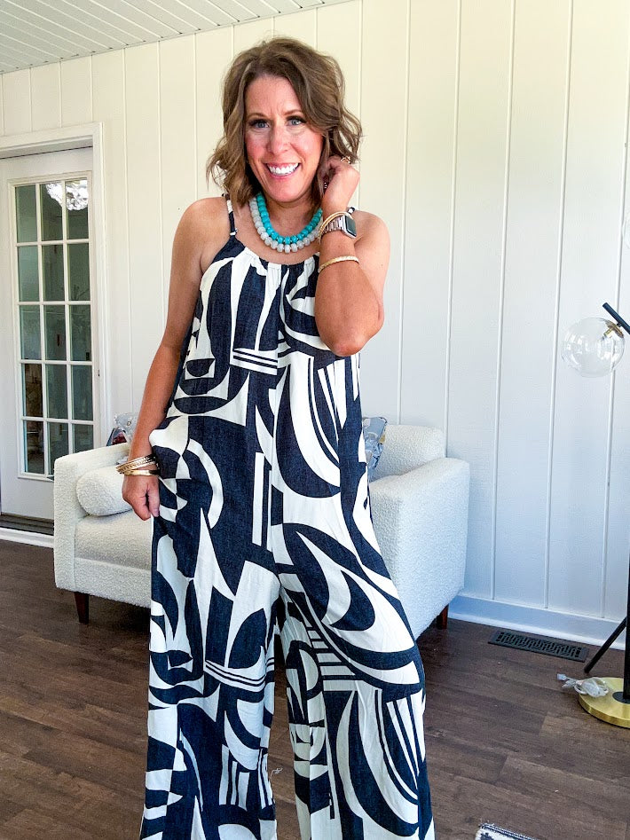 Turn heads this season in our Black + Cream Abstract Trellis Jumpsuit—the effortless piece that does all the work for you. Crafted from lightweight, breathable polyester, this playful abstract print jumpsuit features adjustable straps with a drawstring at the back, elastic neckline details, and a flattering wide-leg silhouette that moves with you. 