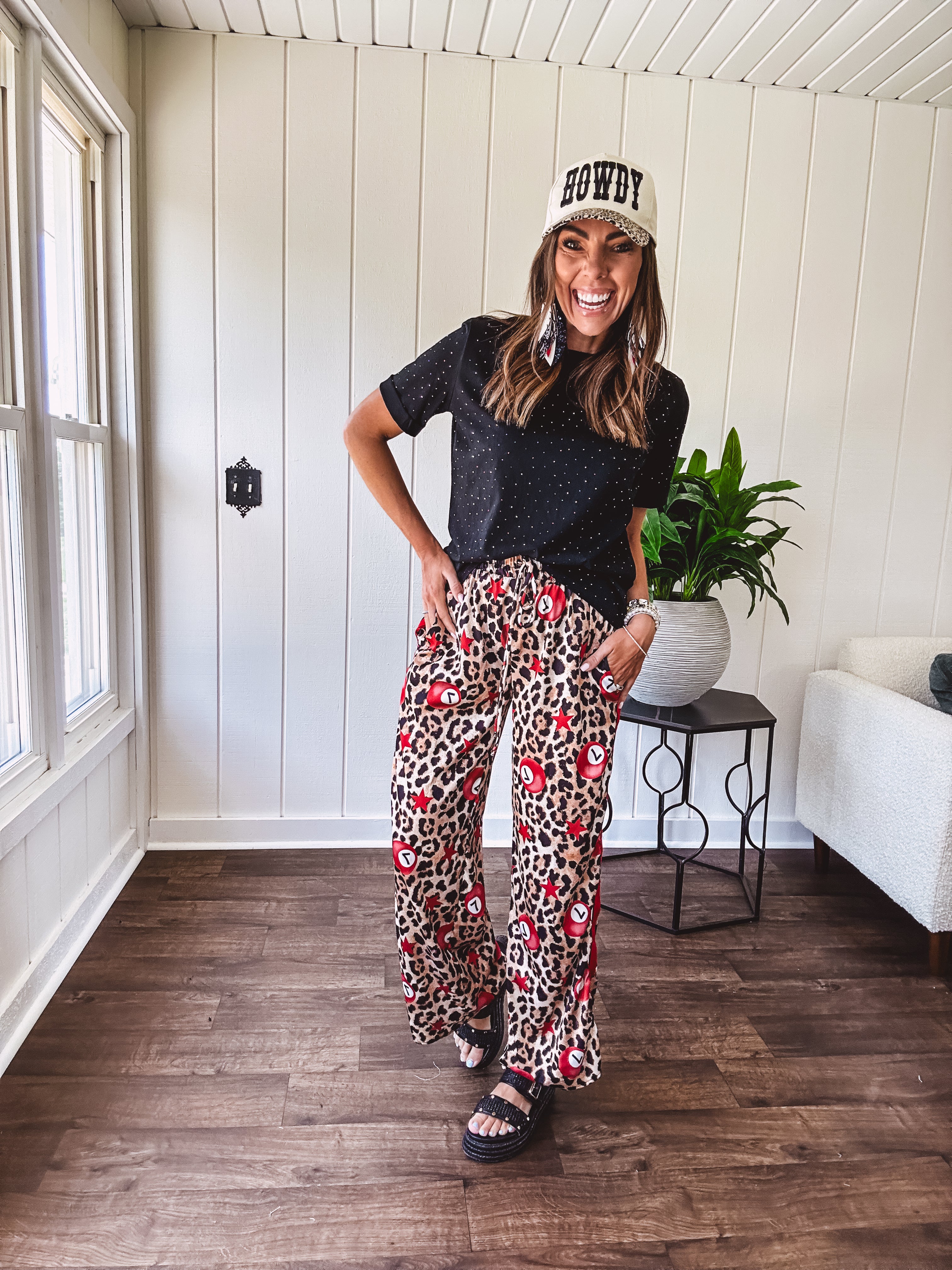 Thin, silky classic leopard design wide leg pants with red number 7 billiard balls throughout with red, white and black stripe down the sides and elastic drawstring waist and pockets.