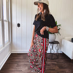Thin, silky classic leopard design wide leg pants with red number 7 billiard balls throughout with red, white and black stripe down the sides and elastic drawstring waist and pockets.