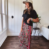 Thin, silky classic leopard design wide leg pants with red number 7 billiard balls throughout with red, white and black stripe down the sides and elastic drawstring waist and pockets.