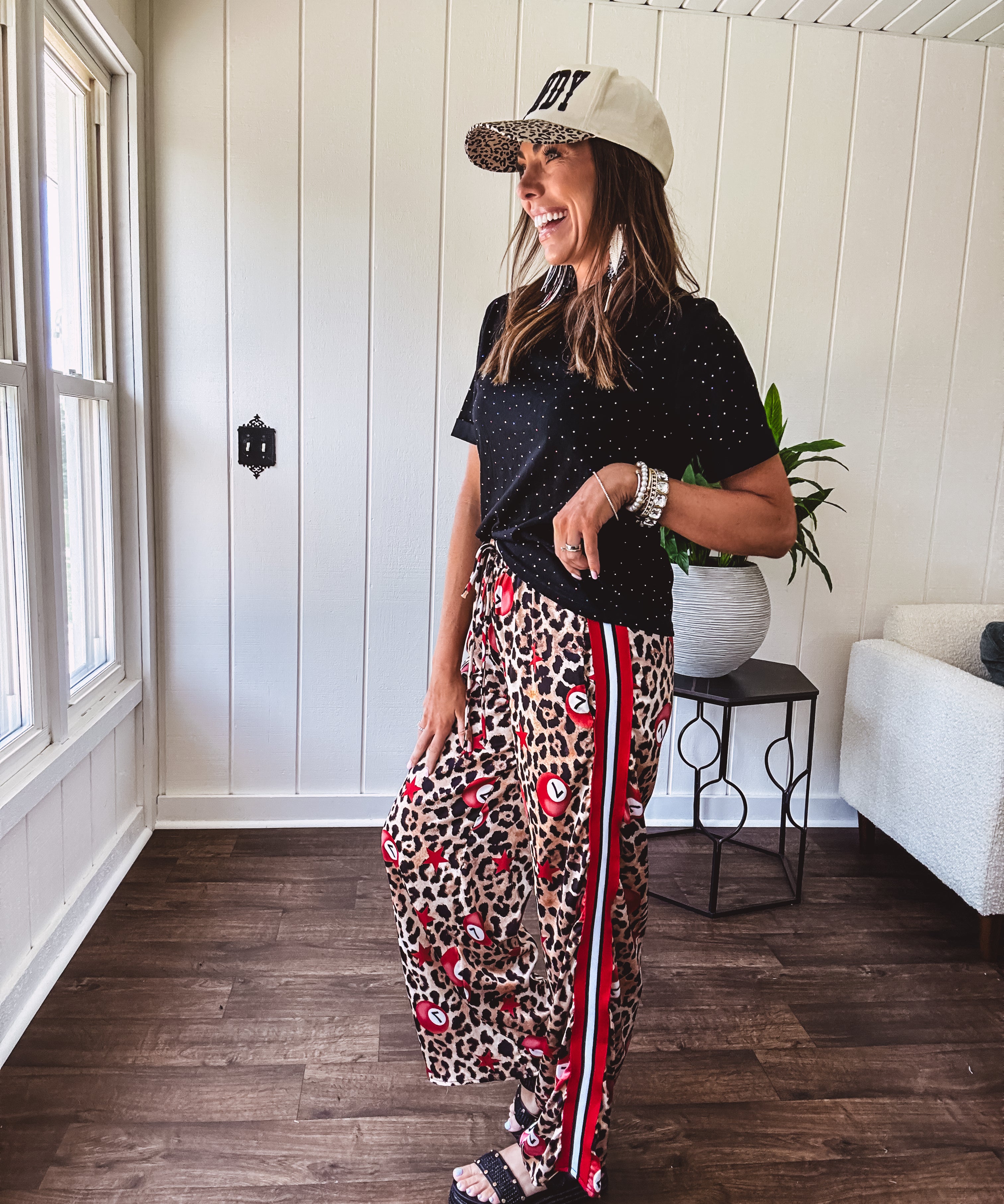 Thin, silky classic leopard design wide leg pants with red number 7 billiard balls throughout with red, white and black stripe down the sides and elastic drawstring waist and pockets.