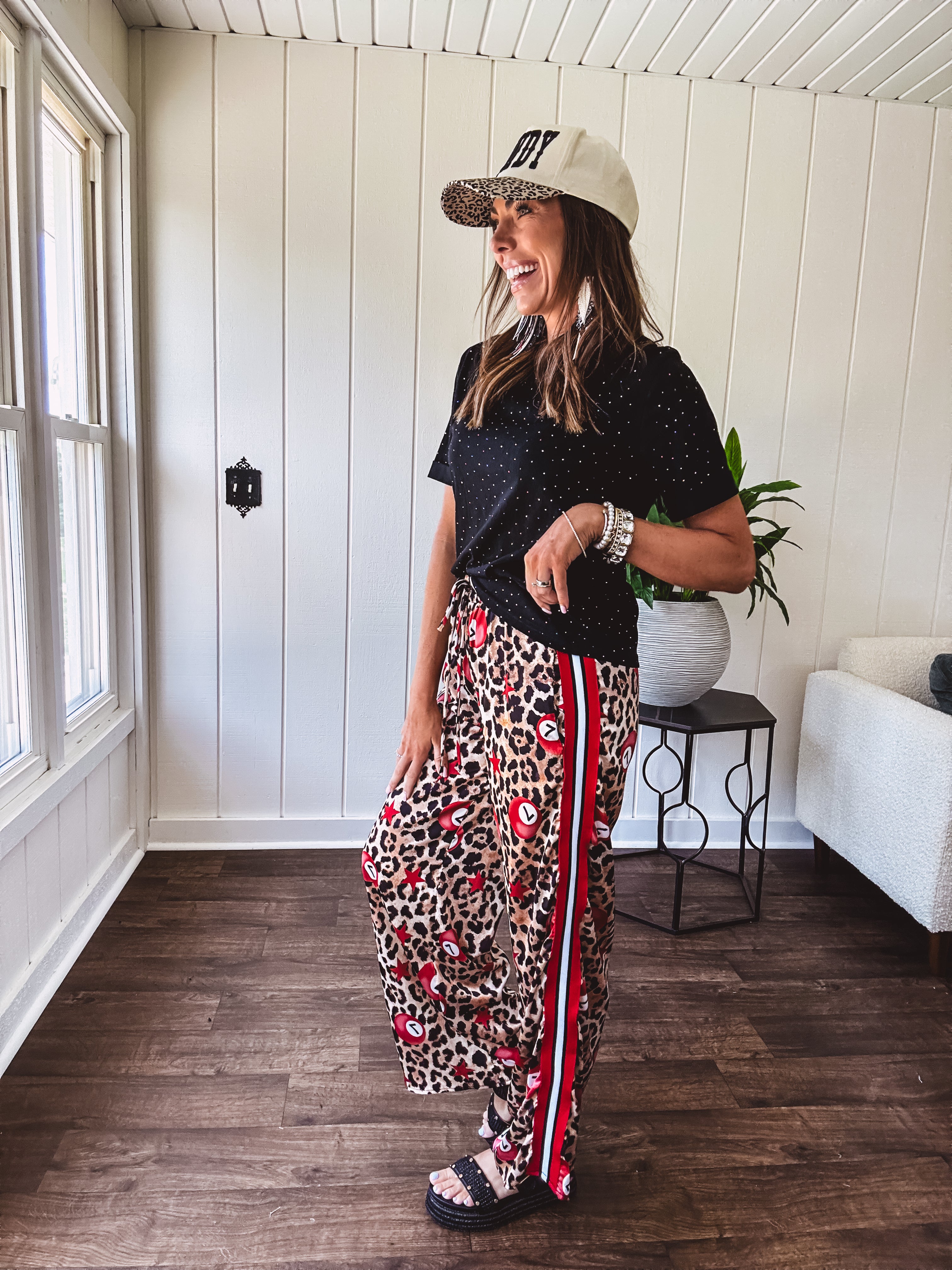 Thin, silky classic leopard design wide leg pants with red number 7 billiard balls throughout with red, white and black stripe down the sides and elastic drawstring waist and pockets.