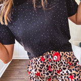 Black cotton short sleeved tee with multi colored mini rhinestones throughout.