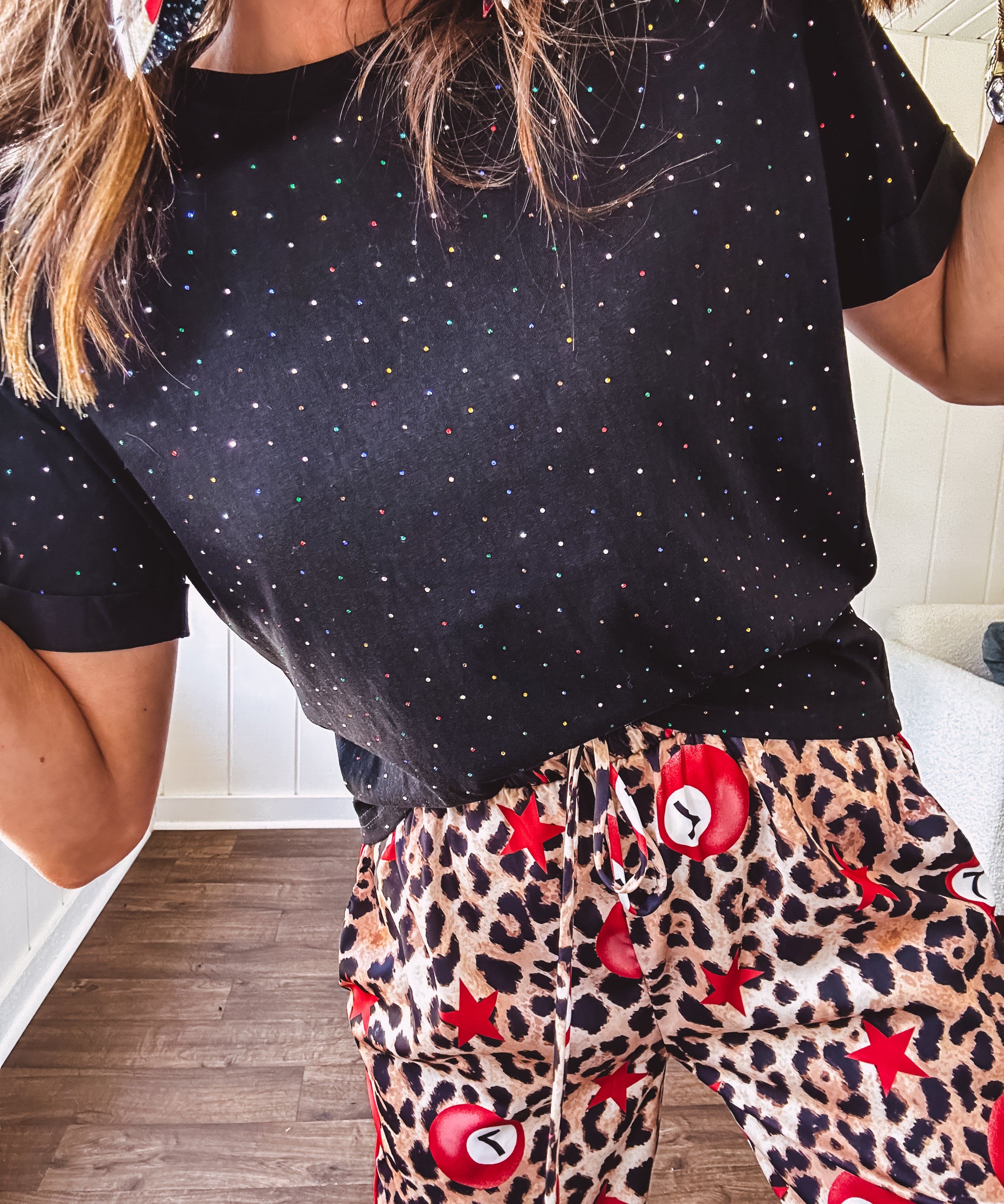 Black cotton short sleeved tee with multi colored mini rhinestones throughout.
