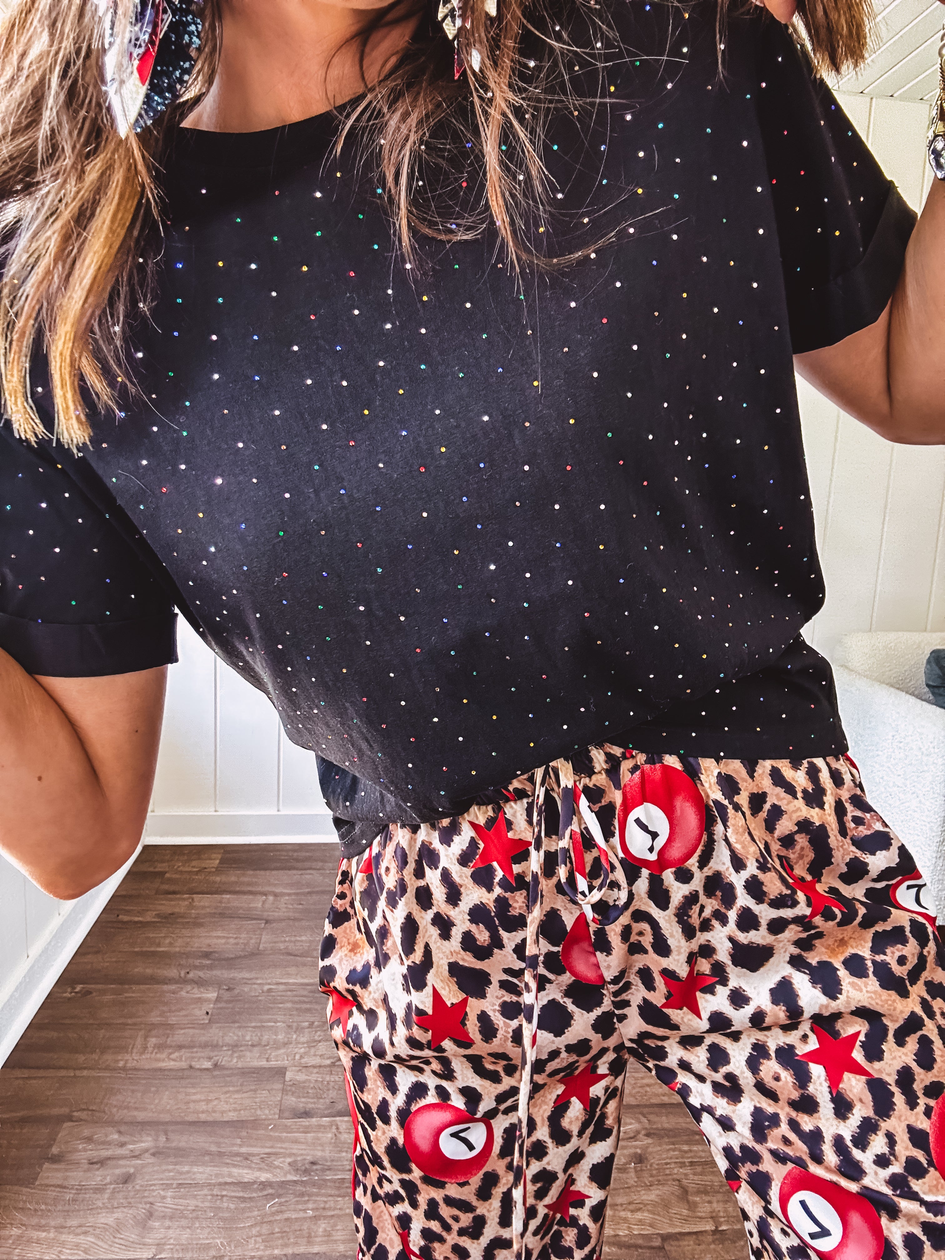 Black cotton short sleeved tee with multi colored mini rhinestones throughout.