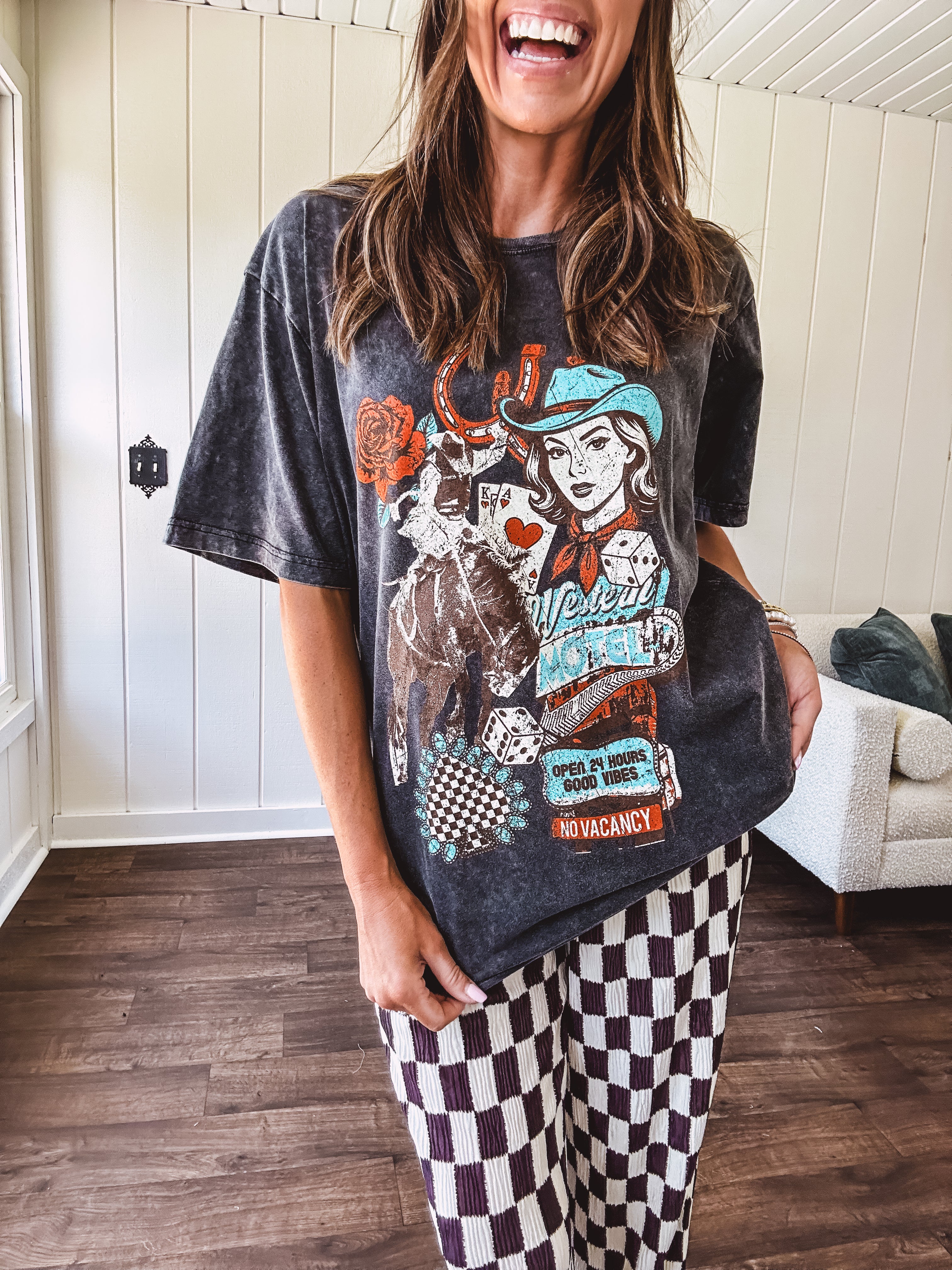 Mineral washed charcoal tee with teal, cream and rust cowgirl graphics and vintage inspired motel pic.