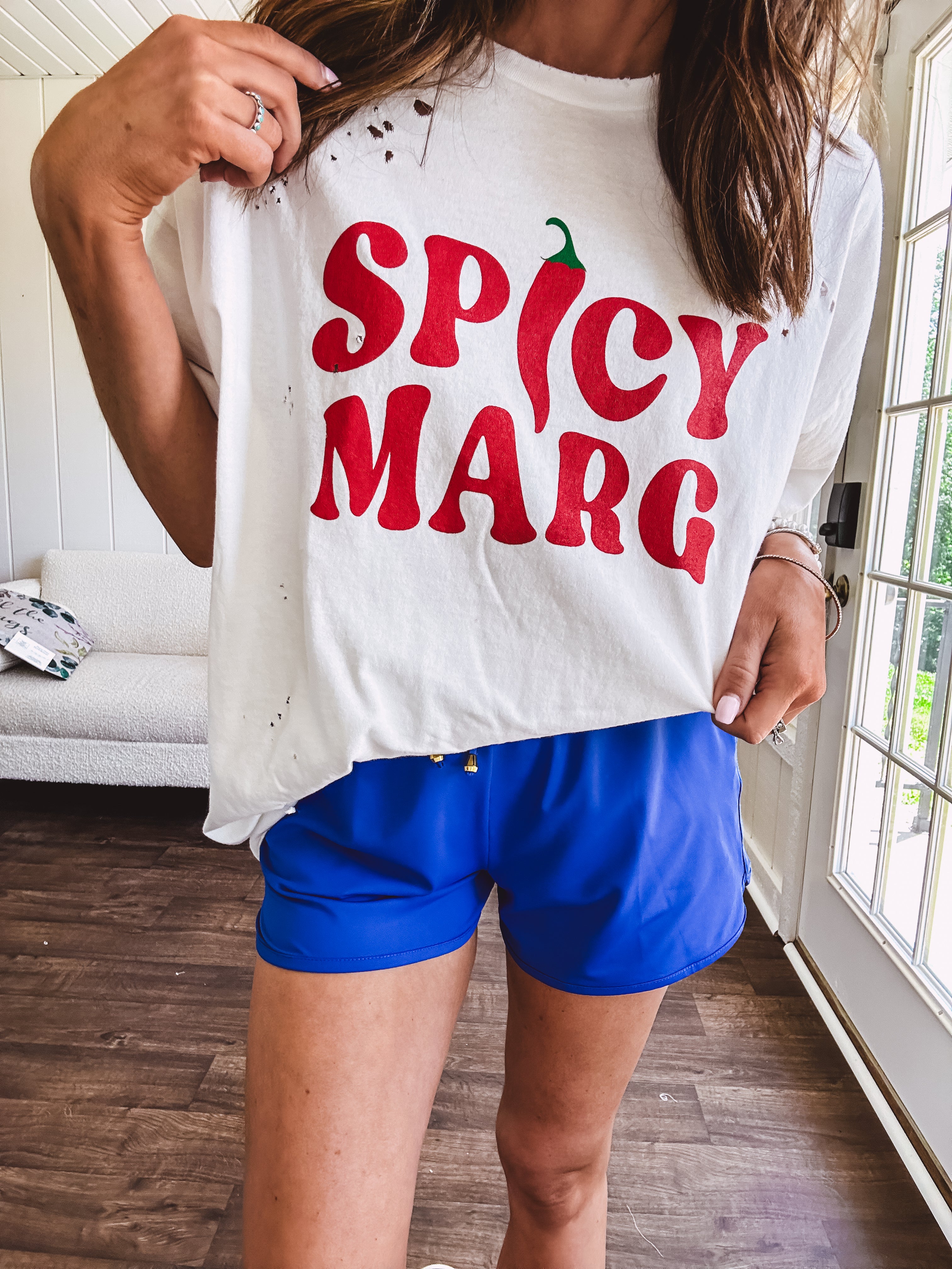 Thin, royal blue athleisure shorts with elastic drawstring waist and pockets.