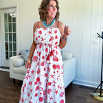 This fully lined white midi features an eye-catching red shell print that demands attention, paired with adjustable red spaghetti straps and a show-stopping red and white striped rope belt complete with charming tassels.